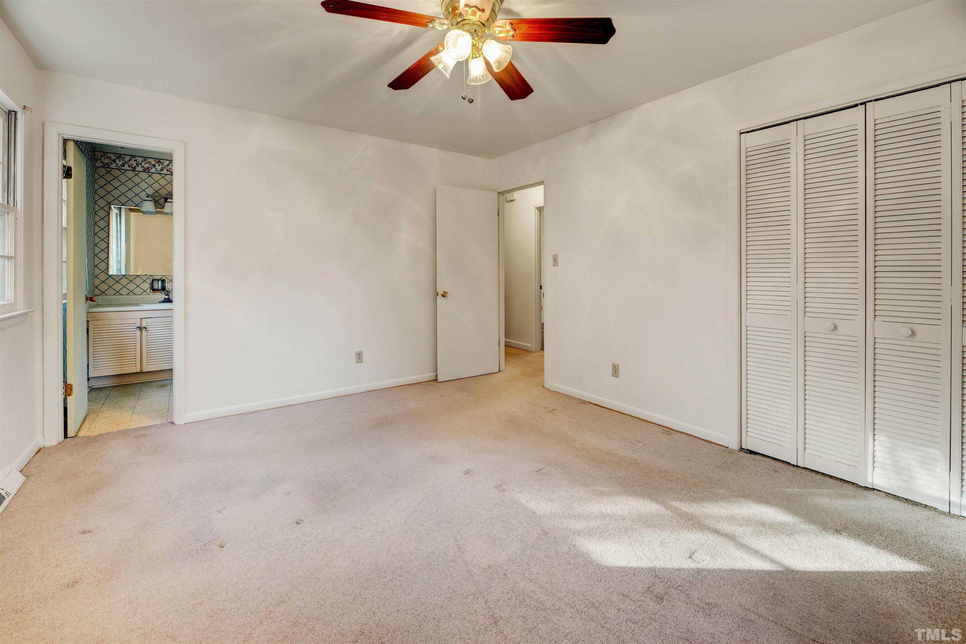 1807 Euclid Road Durham, NC 27713 - Photo 12 of 19 an empty room with chandelier fan and windows
