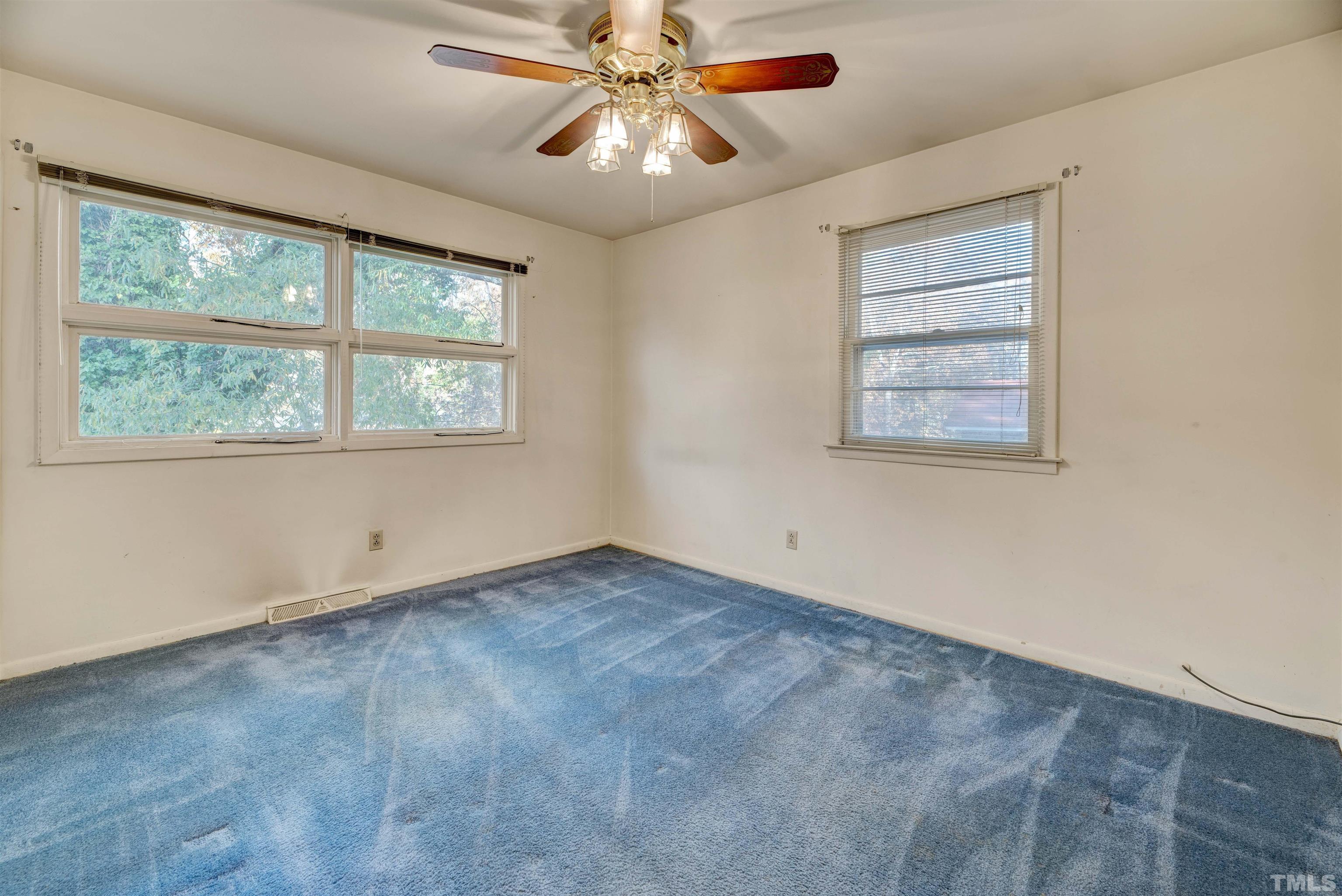 1807 Euclid Road Durham, NC 27713 - Photo 14 of 19 an empty room with a window and a fan