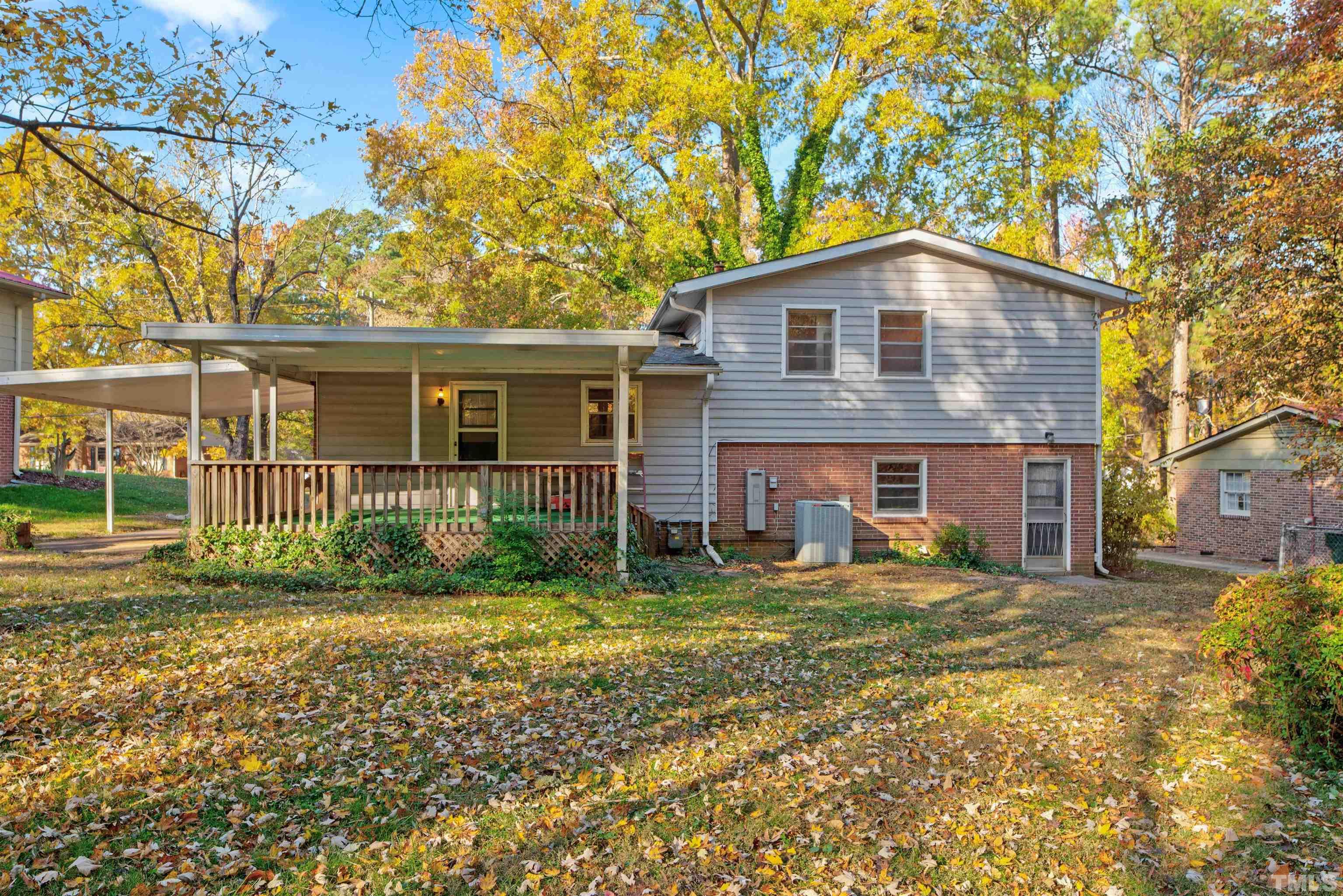 1807 Euclid Road Durham, NC 27713 - Photo 3 of 19 a view of a yard in front of a brick house with large windows