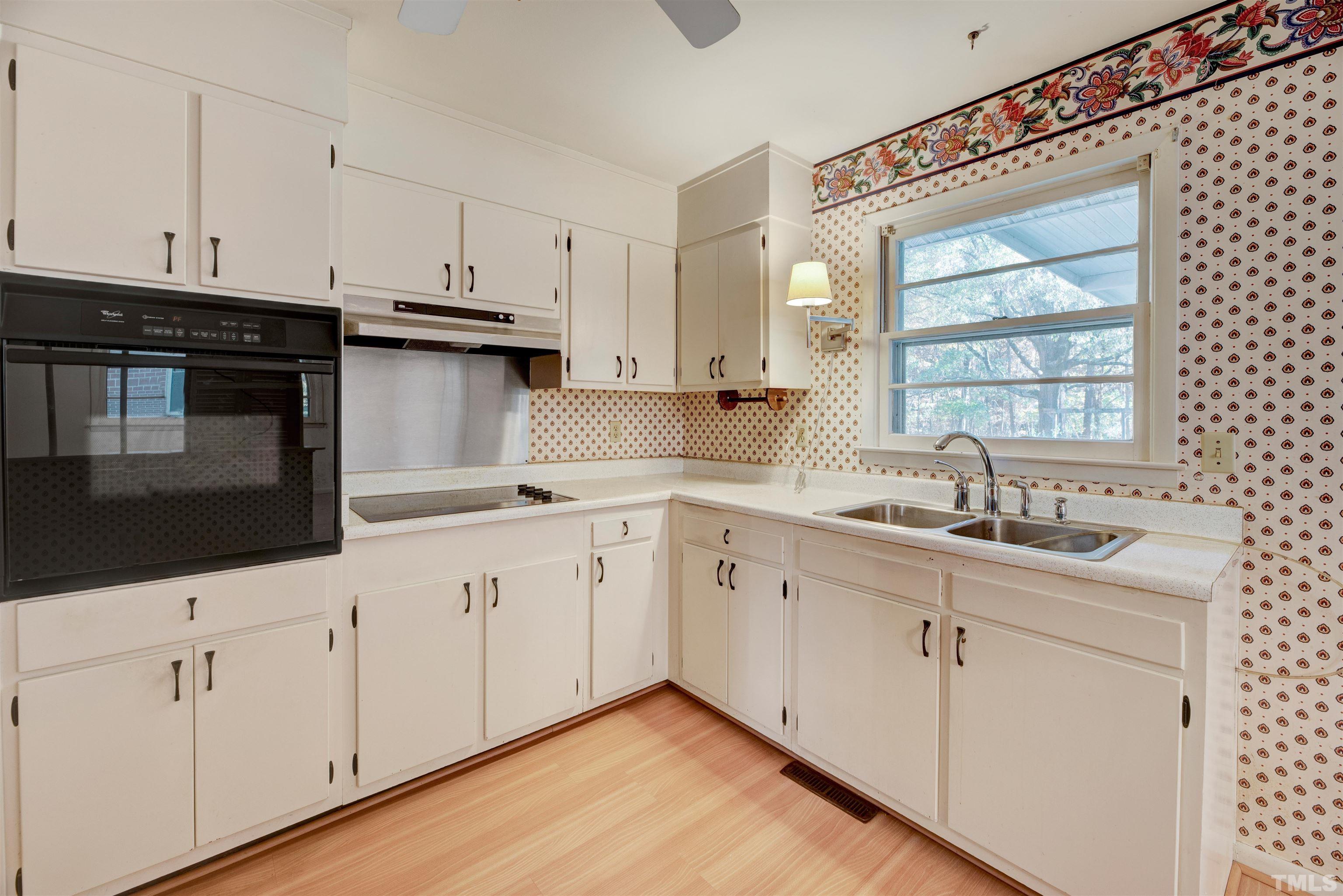 1807 Euclid Road Durham, NC 27713 - Photo 8 of 19 a kitchen with granite countertop white cabinets and sink