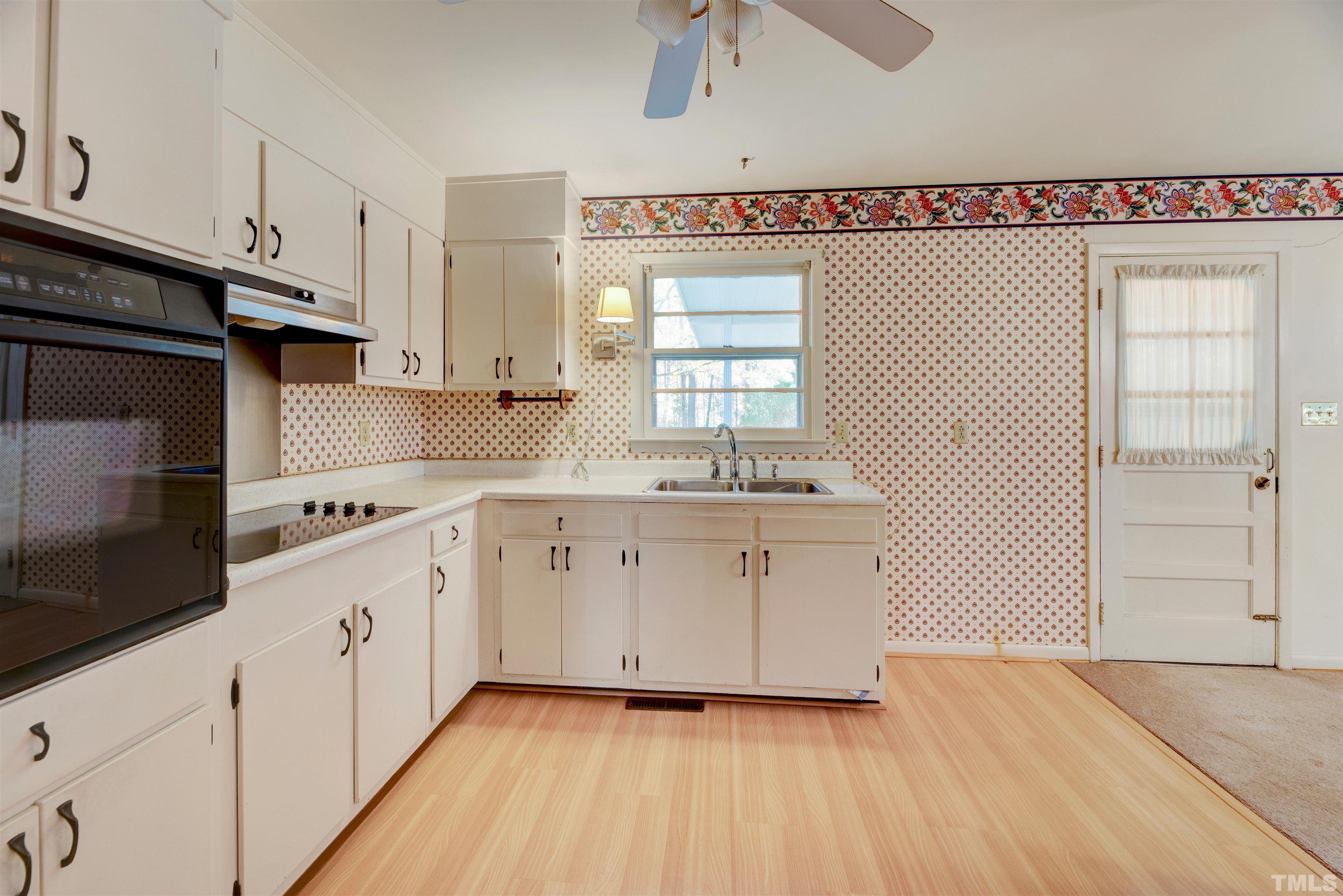 1807 Euclid Road Durham, NC 27713 - Photo 9 of 19 a kitchen with granite countertop white cabinets and white appliances