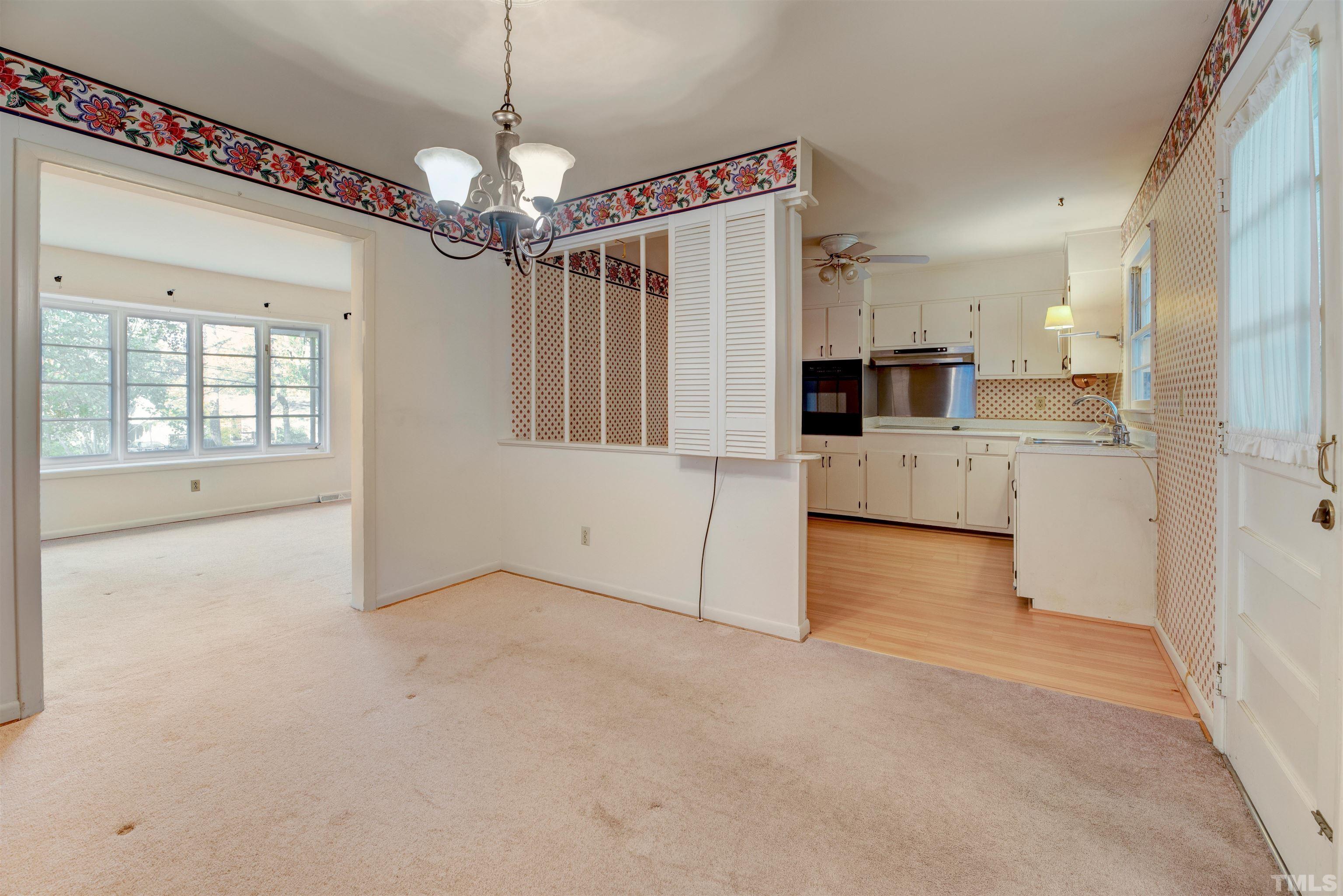 1807 Euclid Road Durham, NC 27713 - Photo 10 of 19 a view of a kitchen with a refrigerator a kitchen island wooden floor and a sink