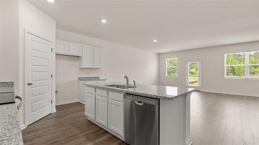635 Whitman Lane Stockbridge, GA 30281 - Photo 12 of 42 a kitchen with granite countertop a sink and a stove top oven