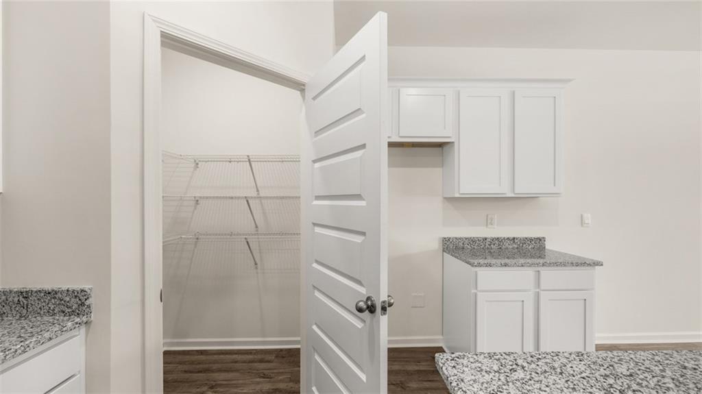 635 Whitman Lane Stockbridge, GA 30281 - Photo 14 of 42 a bathroom with a granite countertop sink and white cabinets