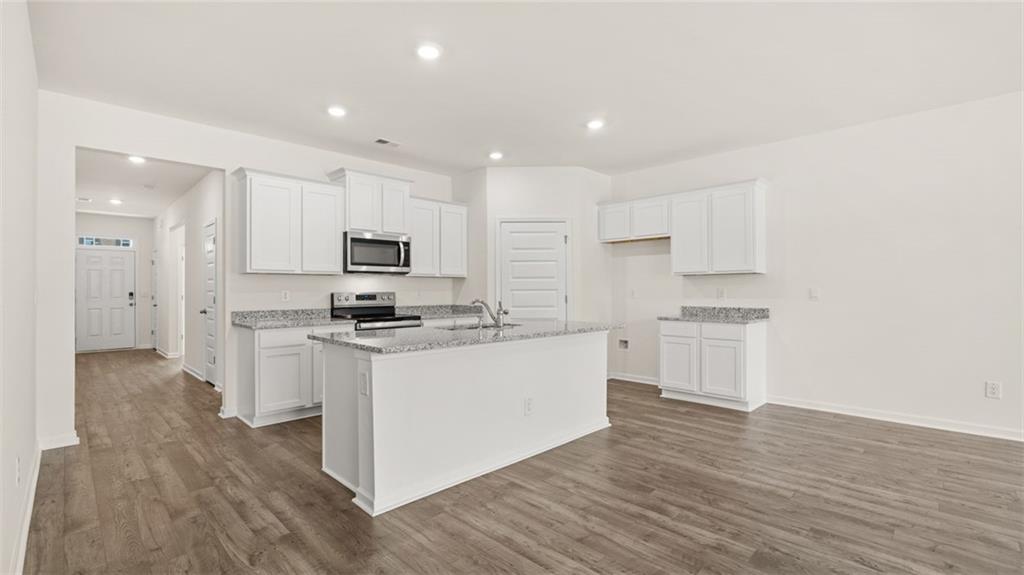 635 Whitman Lane Stockbridge, GA 30281 - Photo 15 of 42 a kitchen with white cabinets and stainless steel appliances