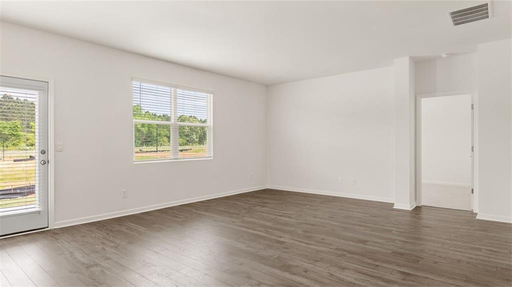 635 Whitman Lane Stockbridge, GA 30281 - Photo 21 of 42 an empty room with wooden floor and windows
