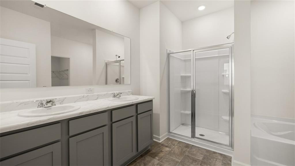 635 Whitman Lane Stockbridge, GA 30281 - Photo 24 of 42 a bathroom with a double vanity sink mirror and shower