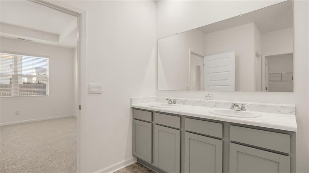 635 Whitman Lane Stockbridge, GA 30281 - Photo 25 of 42 a bathroom with a sink and a mirror