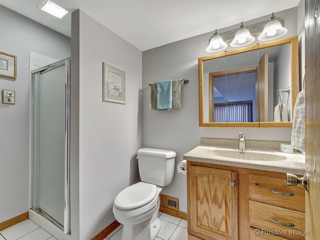 705 Rockhurst Road Bolingbrook, IL 60440 - Photo 14 of 25 a bathroom with a toilet sink and mirror