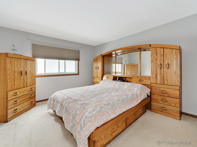 705 Rockhurst Road Bolingbrook, IL 60440 - Photo 15 of 25 a bedroom with a bed and a dresser