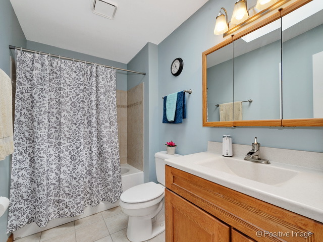 705 Rockhurst Road Bolingbrook, IL 60440 - Photo 16 of 25 a bathroom with a sink toilet and shower