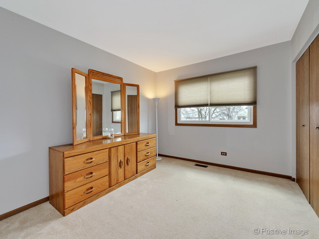 705 Rockhurst Road Bolingbrook, IL 60440 - Photo 17 of 25 an empty room with window and cabinet