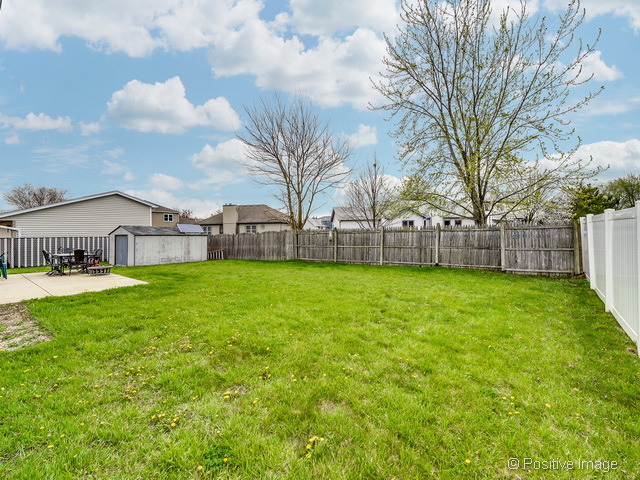 705 Rockhurst Road Bolingbrook, IL 60440 - Photo 23 of 25 a view of a house with a big yard and large tree