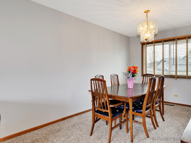 705 Rockhurst Road Bolingbrook, IL 60440 - Photo 6 of 25 a view of a dining room with furniture and window