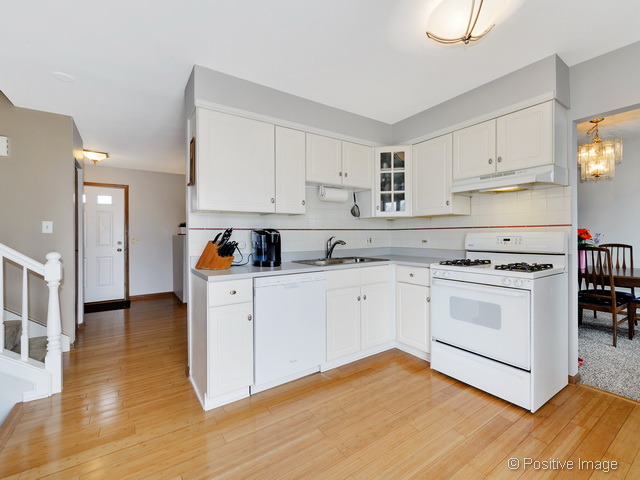 705 Rockhurst Road Bolingbrook, IL 60440 - Photo 7 of 25 a kitchen with white cabinets and white appliances