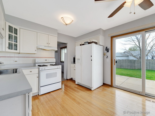 705 Rockhurst Road Bolingbrook, IL 60440 - Photo 8 of 25 a kitchen with white cabinets and white appliances