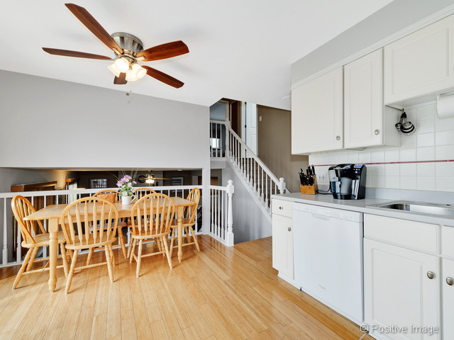 705 Rockhurst Road Bolingbrook, IL 60440 - Photo 9 of 25 a kitchen with white cabinets and stainless steel appliances