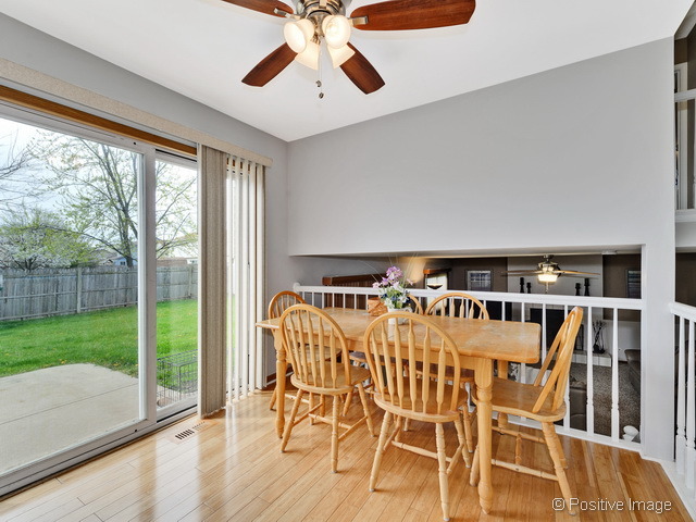 705 Rockhurst Road Bolingbrook, IL 60440 - Photo 10 of 25 a view of a dining room with furniture wooden floor and chandelier