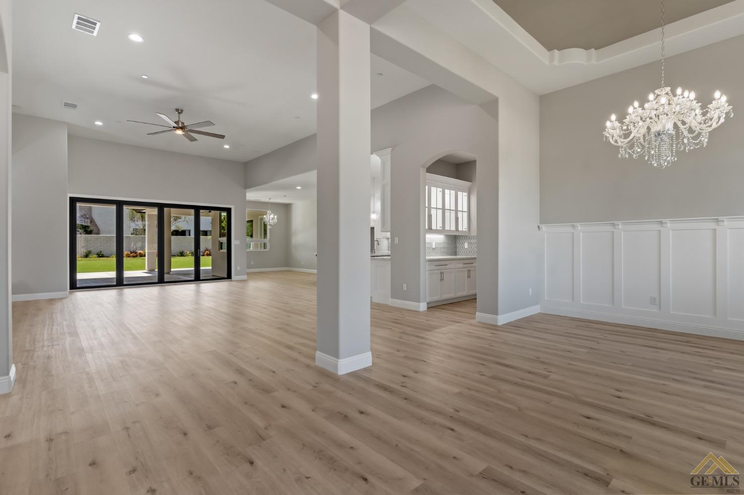 Undisclosed Address Bakersfield, CA 93311 - Photo 11 of 75 a view of an empty room with window and wooden floor
