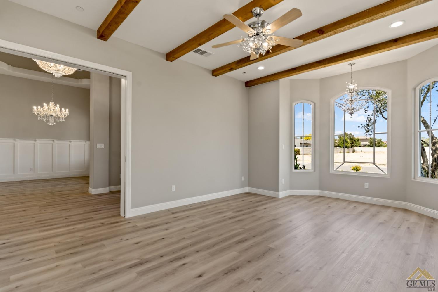 Undisclosed Address Bakersfield, CA 93311 - Photo 17 of 75 a view of an empty room with window and wooden floor