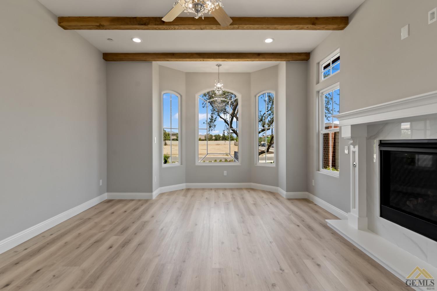 Undisclosed Address Bakersfield, CA 93311 - Photo 18 of 75 a view of an empty room with a window and wooden floor