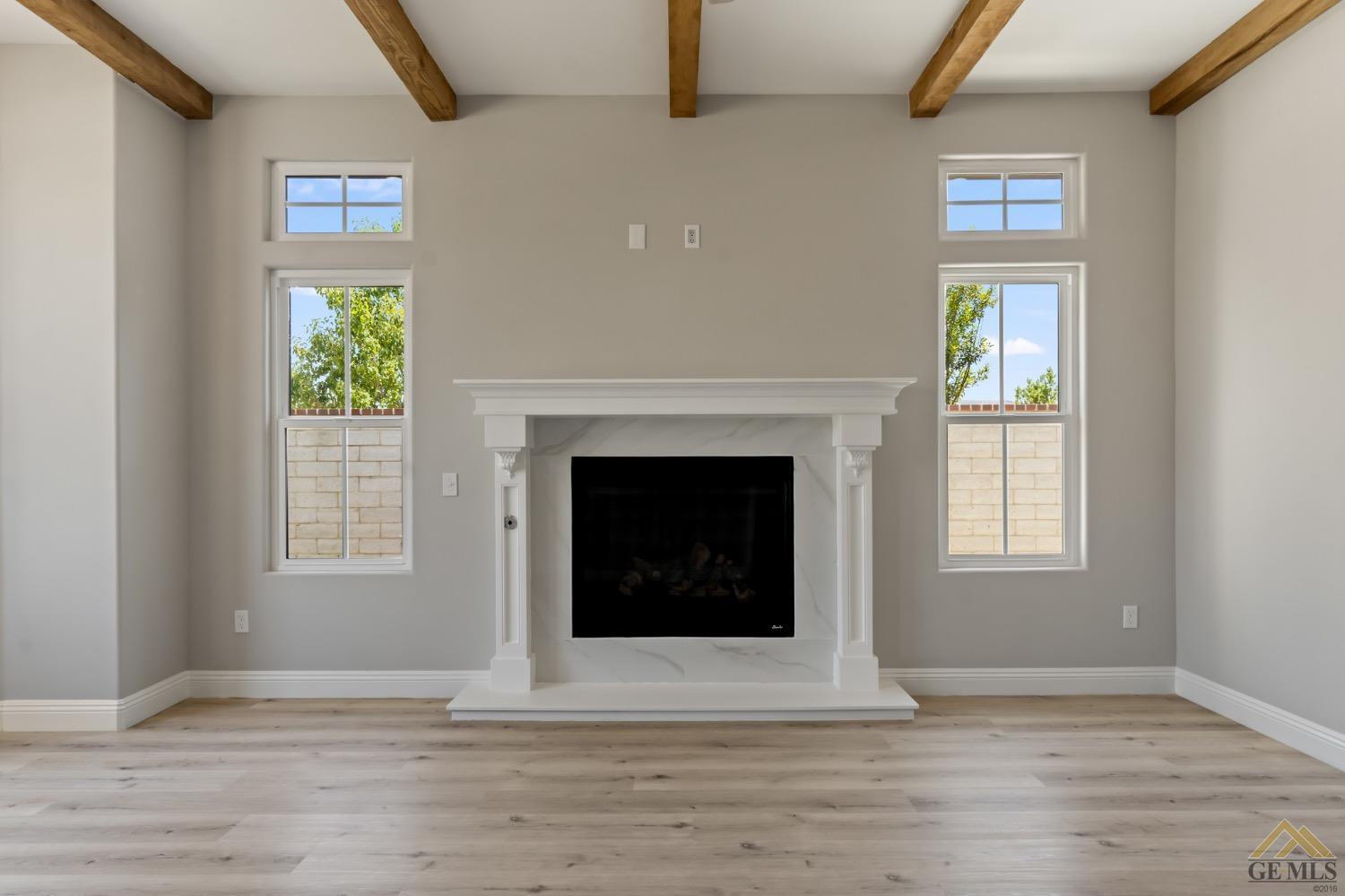 Undisclosed Address Bakersfield, CA 93311 - Photo 20 of 75 a view of an empty room with wooden floor and a window
