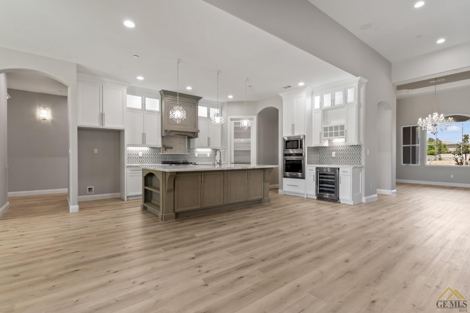 Undisclosed Address Bakersfield, CA 93311 - Photo 21 of 75 a large kitchen with stainless steel appliances kitchen island granite countertop a large cabinets a sink and a refrigerator