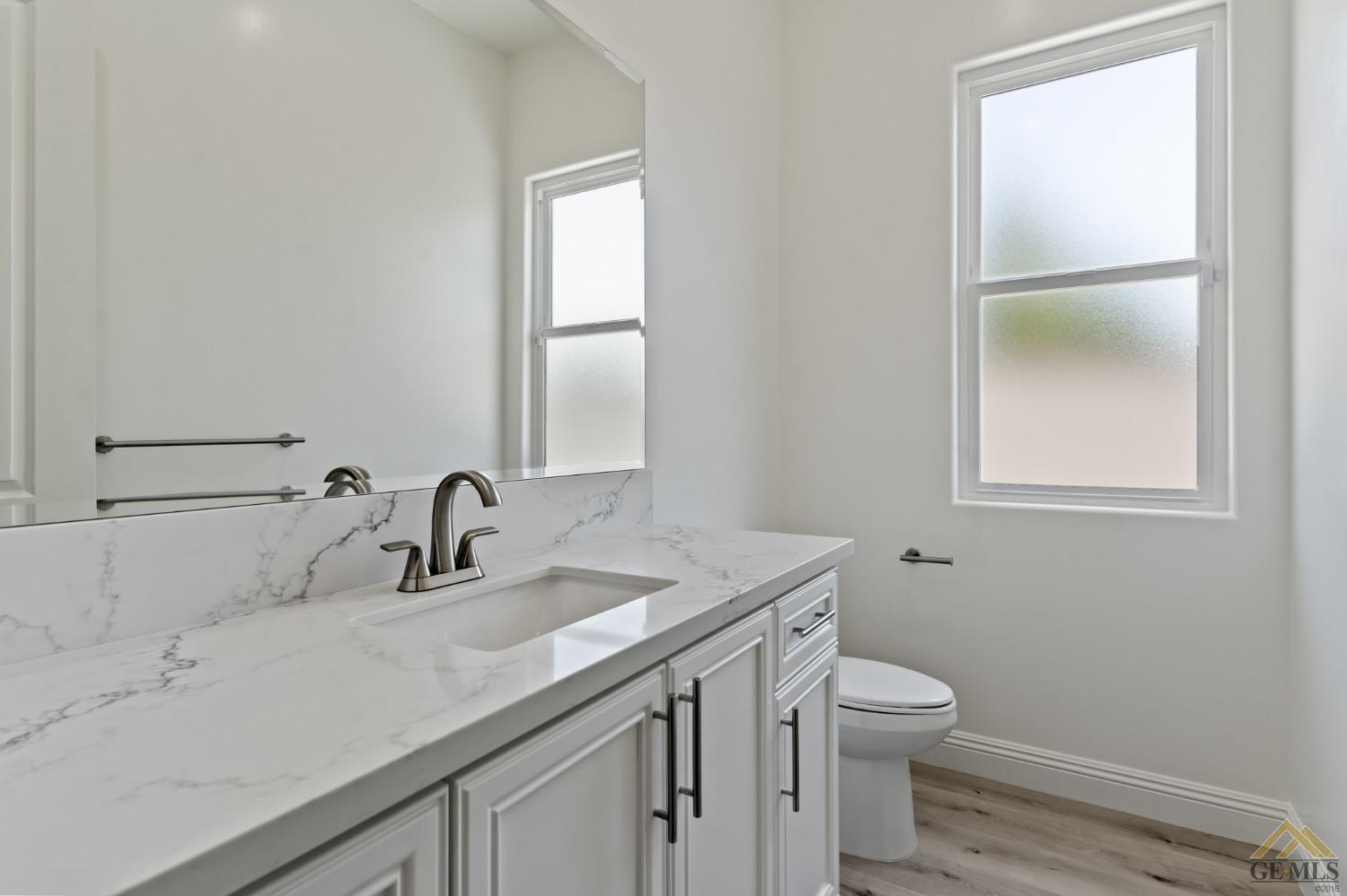 Undisclosed Address Bakersfield, CA 93311 - Photo 31 of 75 a bathroom with a sink toilet and vanity