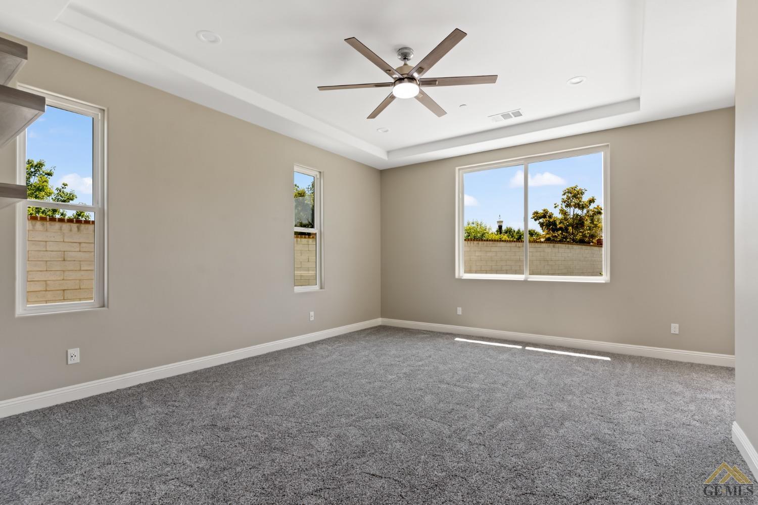 Undisclosed Address Bakersfield, CA 93311 - Photo 32 of 75 an empty room with windows and ceiling fan