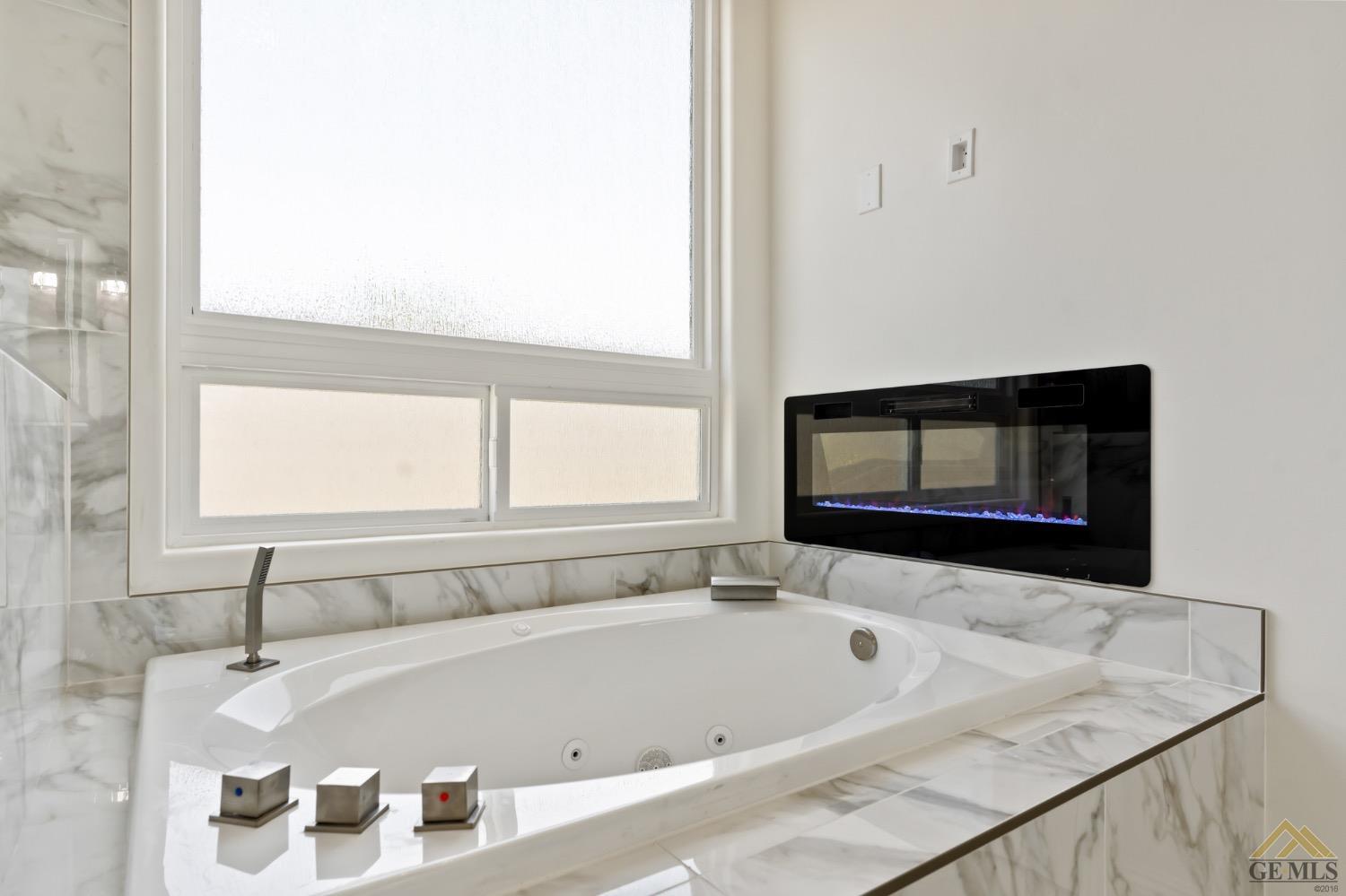 Undisclosed Address Bakersfield, CA 93311 - Photo 38 of 75 a bath tub sitting in a bathroom next to a window