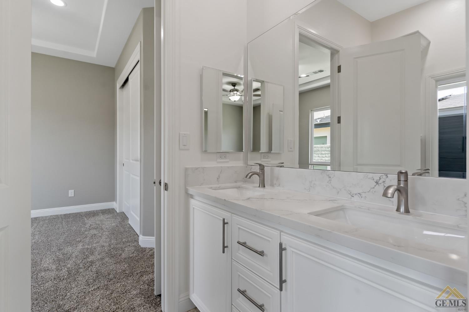 Undisclosed Address Bakersfield, CA 93311 - Photo 46 of 75 a bathroom with a double vanity sink and a mirror