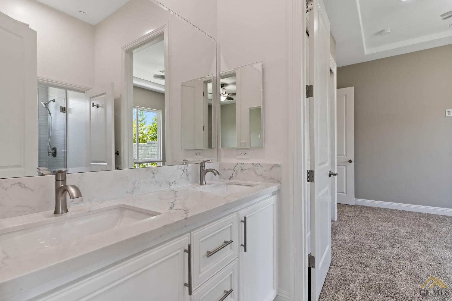 Undisclosed Address Bakersfield, CA 93311 - Photo 48 of 75 a bathroom with a double vanity sink and a mirror