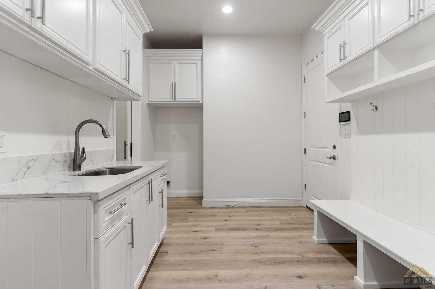 Undisclosed Address Bakersfield, CA 93311 - Photo 61 of 75 a kitchen with a sink and a refrigerator