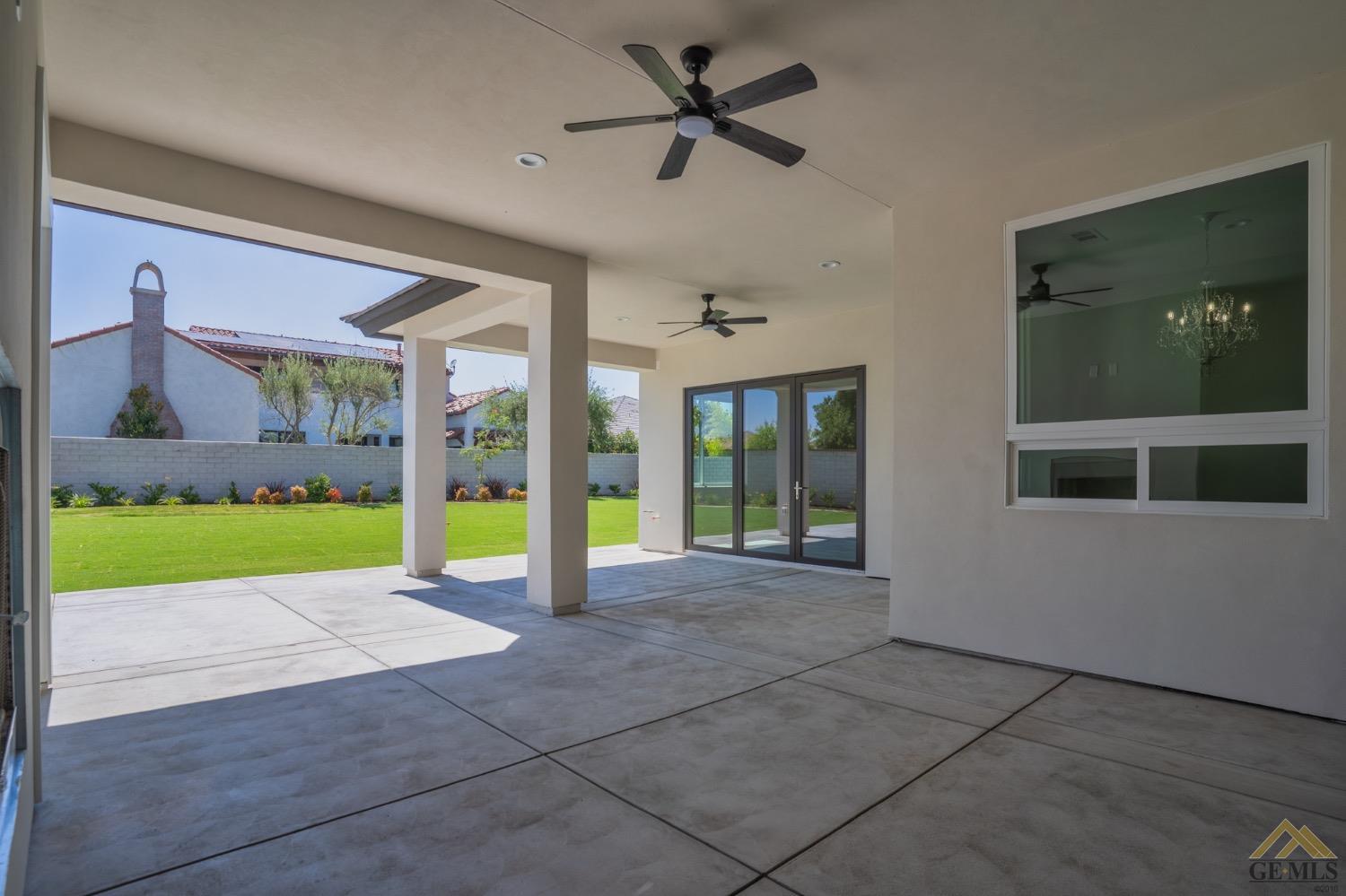 Undisclosed Address Bakersfield, CA 93311 - Photo 63 of 75 a view of an empty room with a floor to ceiling window and a ceiling fan