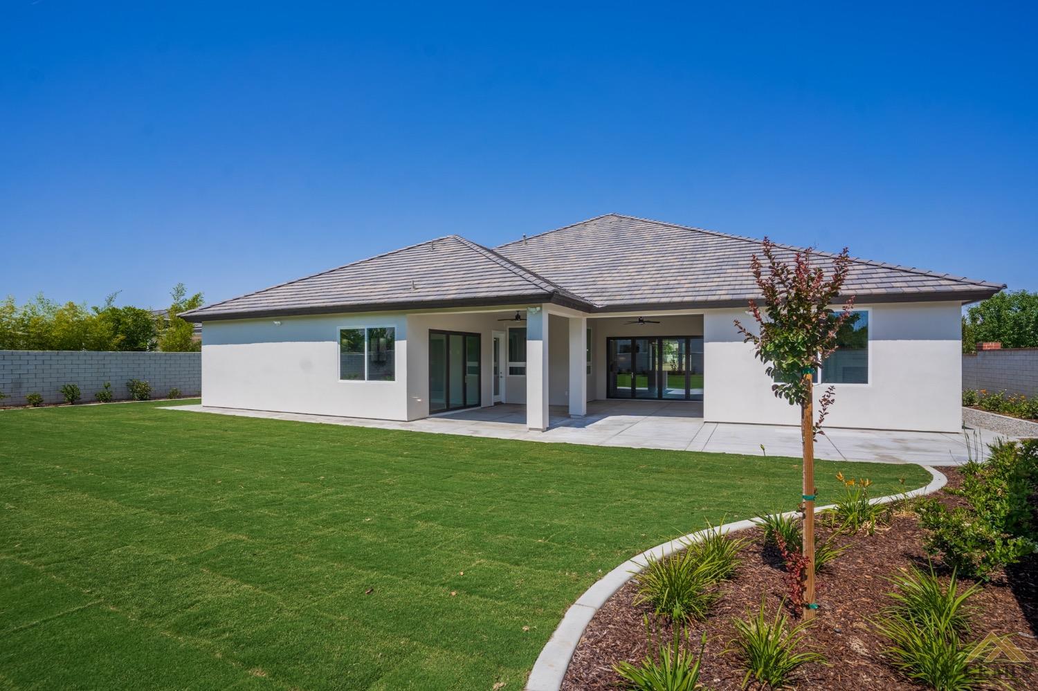 Undisclosed Address Bakersfield, CA 93311 - Photo 68 of 75 a front view of a house with a garden