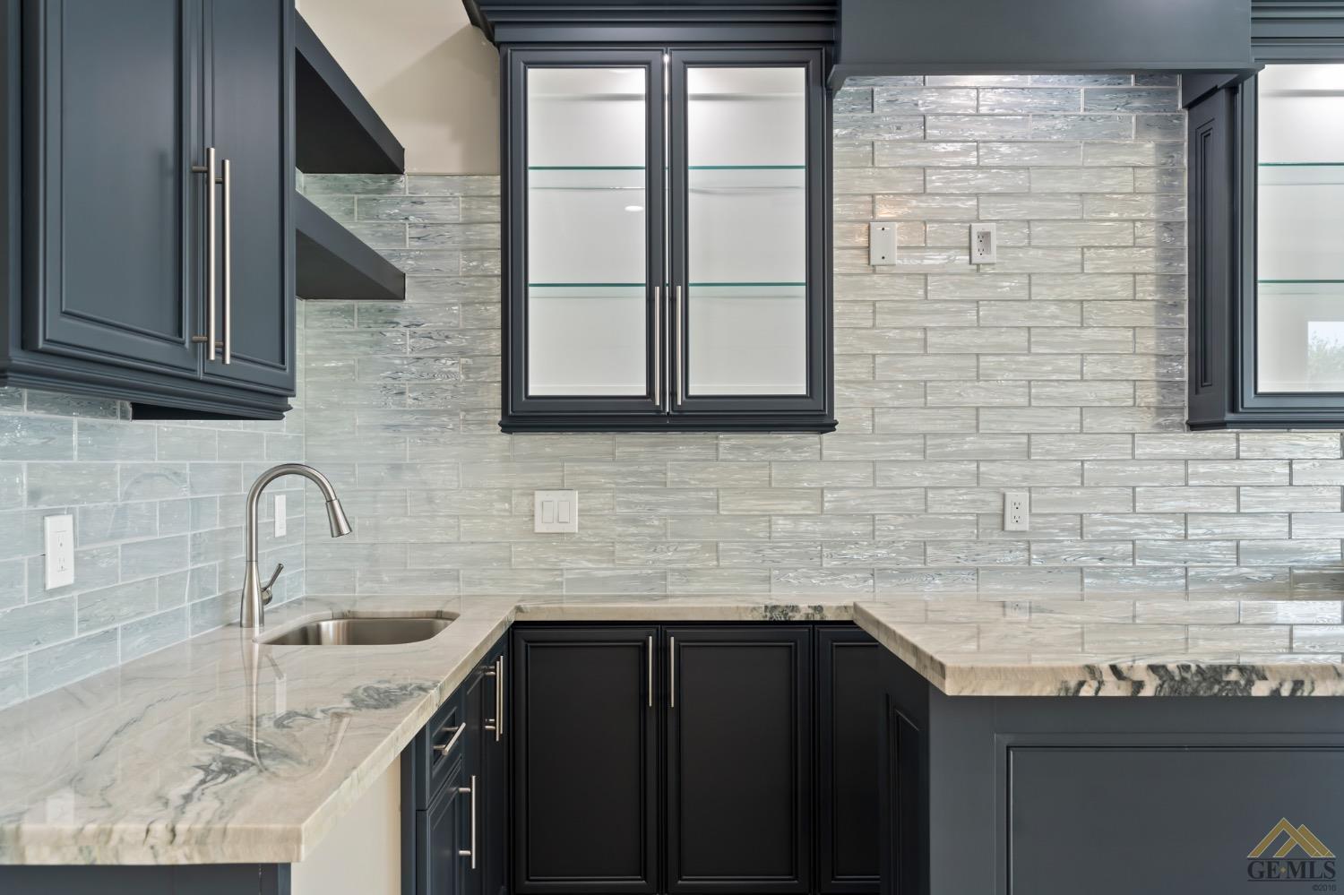 Undisclosed Address Bakersfield, CA 93311 - Photo 75 of 75 a kitchen with granite countertop a sink and a wooden cabinets