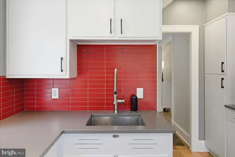 a kitchen with a refrigerator and a stove top oven