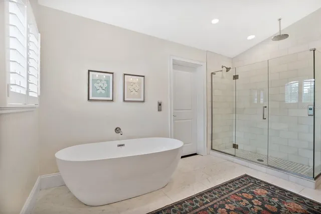 a bathroom with a bathtub and shower