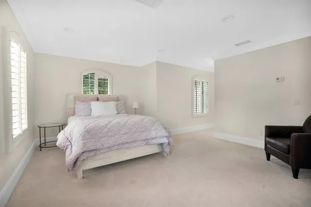 a bedroom with a bed couch and a window