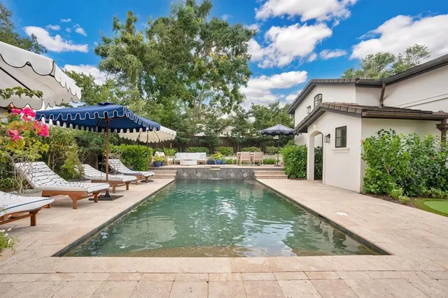 a view of a swimming pool with a patio