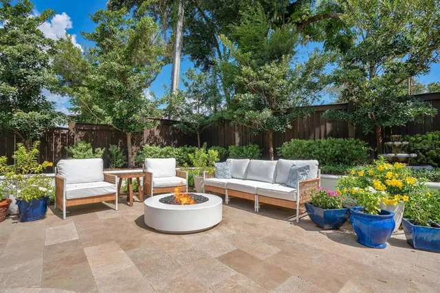 a view of a patio with couches and potted plants