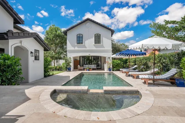 a view of a white house with swimming pool