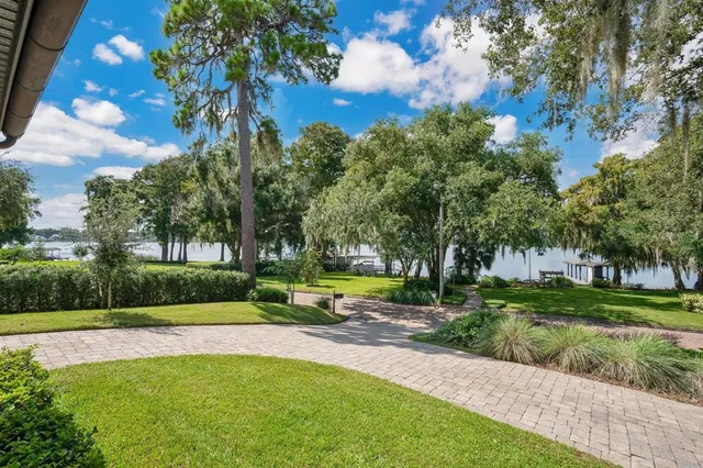 a view of backyard with swimming pool and green space
