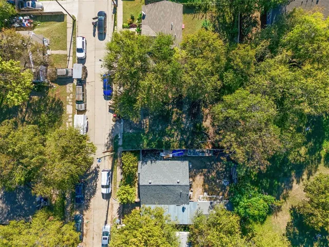 an aerial view of a house with a yard and garden