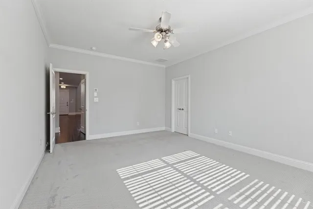 a view of a room with a ceiling fan