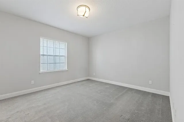 an empty room with a empty space and windows