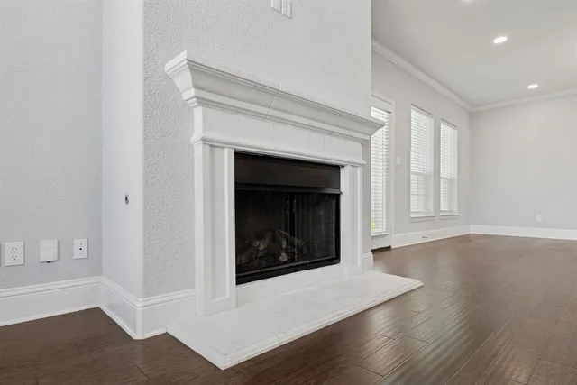 a living room with a fireplace and wooden floor