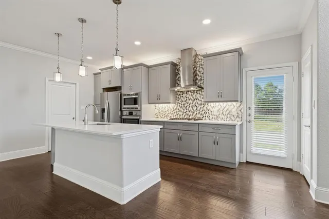 a kitchen with white cabinets and sink