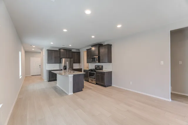 a kitchen with a sink stainless steel appliances and cabinets