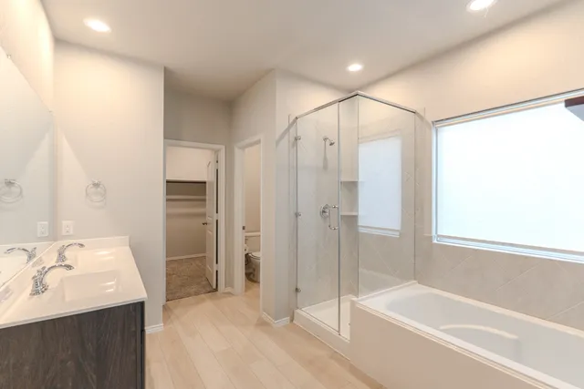 a bathroom with a double vanity sink mirror and shower